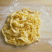 Ribbon pasta on floured wooden board