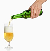 Woman's hand pouring beer