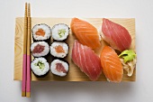 Maki sushi and nigiri sushi on sushi board