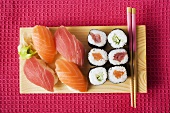 Nigiri sushi and maki sushi on sushi board
