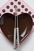 Heart-shaped bowl with fondue forks