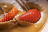 Dipping strawberries in chocolate sauce