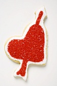 Heart-shaped biscuit with arrow decorated with red sugar