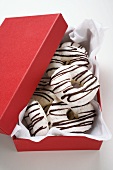 Almond and coffee macaroons in red gift box