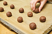 Small balls of hazelnut dough on a baking tray