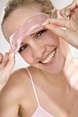 Young woman with cool eye mask