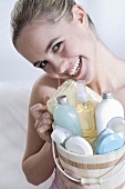 Young woman holding a basket of cosmetics