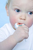 Small boy sucking a lollipop