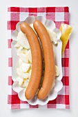 A pair of frankfurters on potato salad