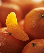 Whole tangerines and one segment