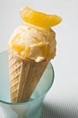 Orange ice cream in wafer cone in a beaker