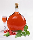 Bottle and glass of raspberry liqueur