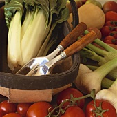 Fresh organic vegetables and garden tools in trug