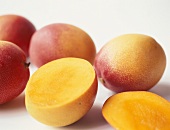 Fresh mangos, one halved
