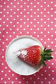 Strawberry in a bowl of sugar