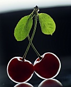 Two cherries with stalk and leaves