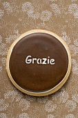 A biscuit with the word 'Grazie'