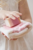 Girl holding soap and towel