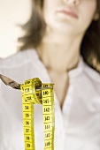 Woman holding a tape measure on a fork