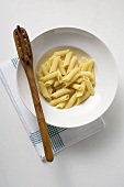 Plate of penne rigate and spaghetti server