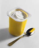 Yoghurt in a yellow plastic pot