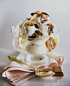 Vanilla ice cream with nuts and raisins in a sundae glass