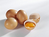 Whole eggs and one broken egg in its shell