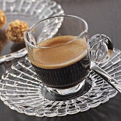 Espresso in a glass cup and saucer