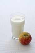 A glass of milk and an apple