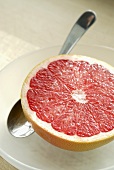 Half a pink grapefruit with spoon