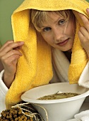 Young woman taking a chamomile steam bath
