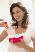 Woman with perfume in gift wrappings