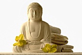 Buddha statue with orchid flowers