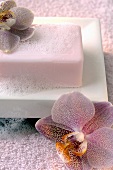 Soap with lather in a soap dish, orchids