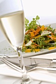 Plate of salad and glass of sparkling wine
