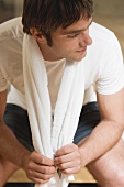Young man with towel after workout
