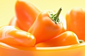 Orange peppers in a bowl (close-up)