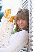 Young woman with baguettes