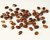 Coffee beans on a white surface