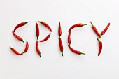 The word 'SPICY' written in red chillies