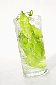 Peas in pods in a glass of water