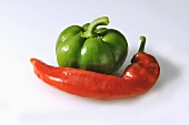 A green pepper and a red chili pepper
