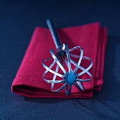 A whisk on a towel