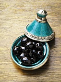 Black olives in a tajine-shaped dish