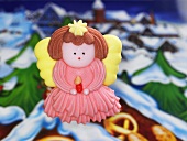 A sugar Christmas angel with a winter landscape in the background