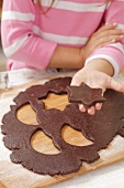 A girl holding a cut-out star-shaped biscuit