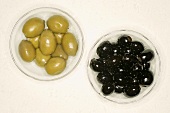 Black and green olives in glass bowls