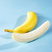 One unpeeled and one peeled banana