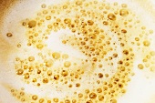 Surface of milky coffee with frothy milk
