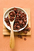 Cranberries in a bowl with wooden spoon